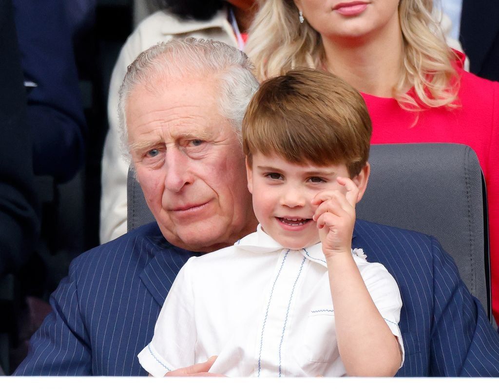 Prince Louis sitting in the lap of his grandfather Carlos in the celebrations of Platinum Jubilee of the late Queen Elizabeth II in 2022.