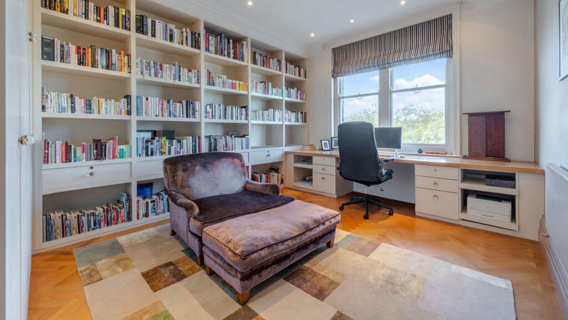 Office with wall to wall library, Chaise Longue, desk area under the window, office chair and carpet