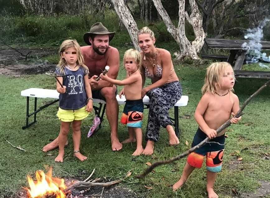 Middle plane of Chris Hemsworth and Elsa Pataky lighting a bonfire with their children