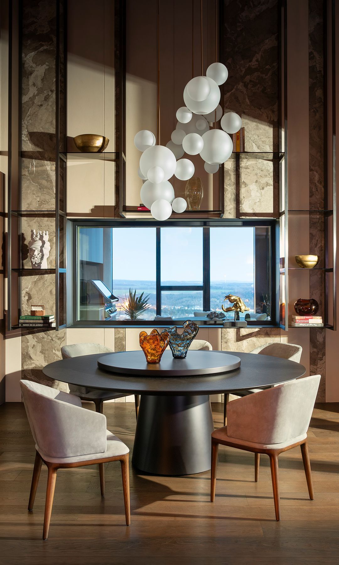 Black round table, ceiling lamp with white balloons, half crystal septum communicates with outdoor kitchen