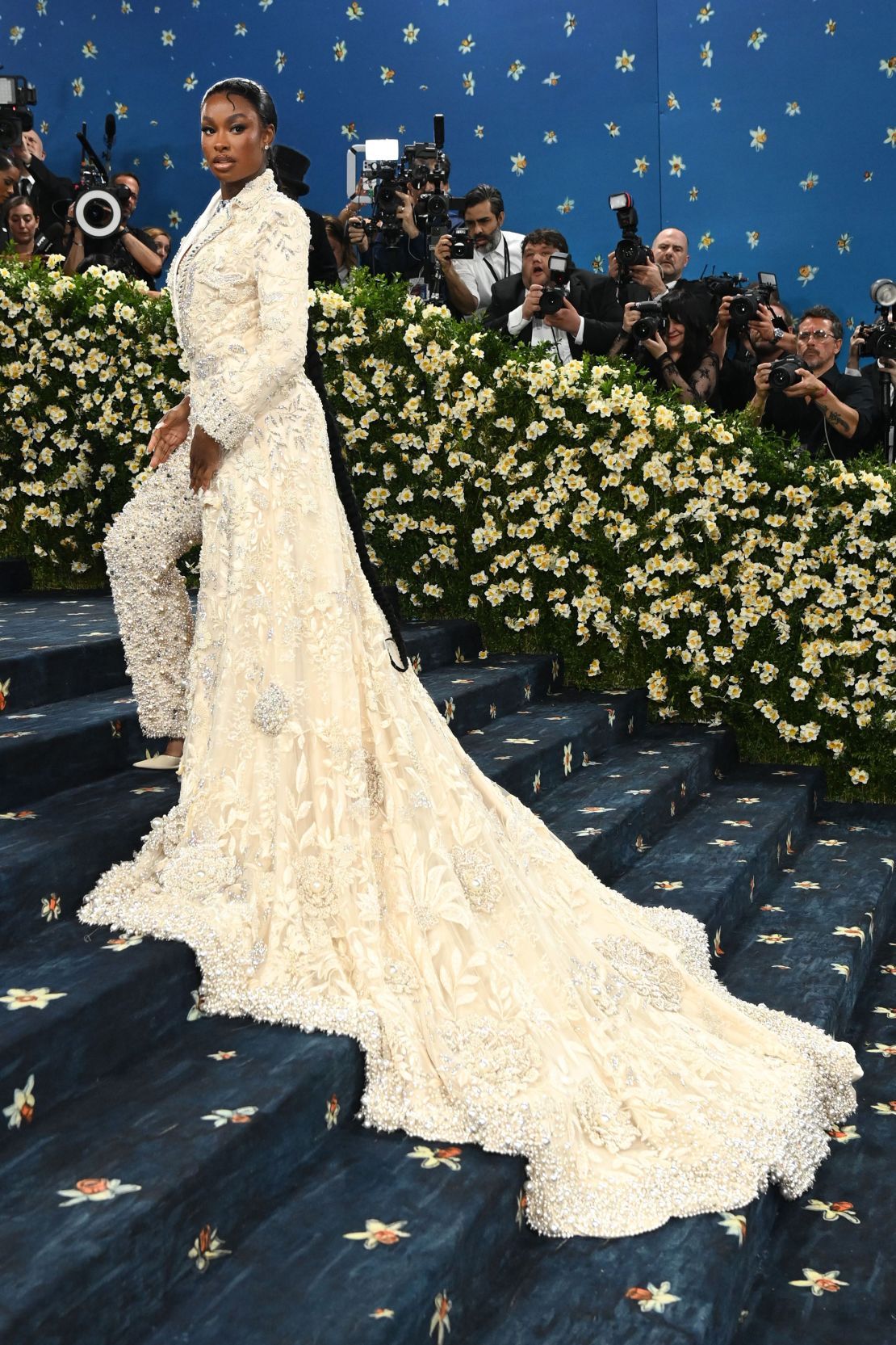Coco Jones’ custom Manish Malhotra attire was a regal hybrid of structure and movement, with her floral applique-embroidered blazer descending into a floor-sweeping train. “This is where fashion meets intention,” Jones said of the event’s theme.