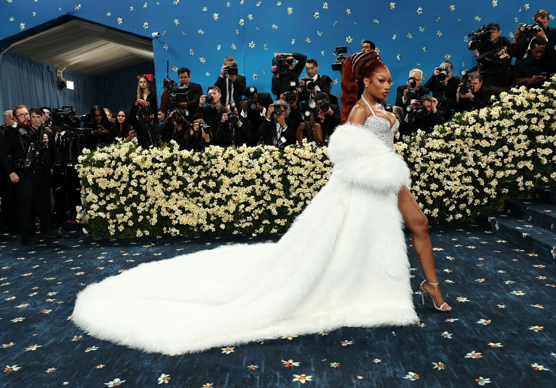 Megan Thee Stallion channels singers Josephine Baker and Eartha Kitt, with her beehive-esque ponytail reminiscent of a hairstyle once worn by the former.