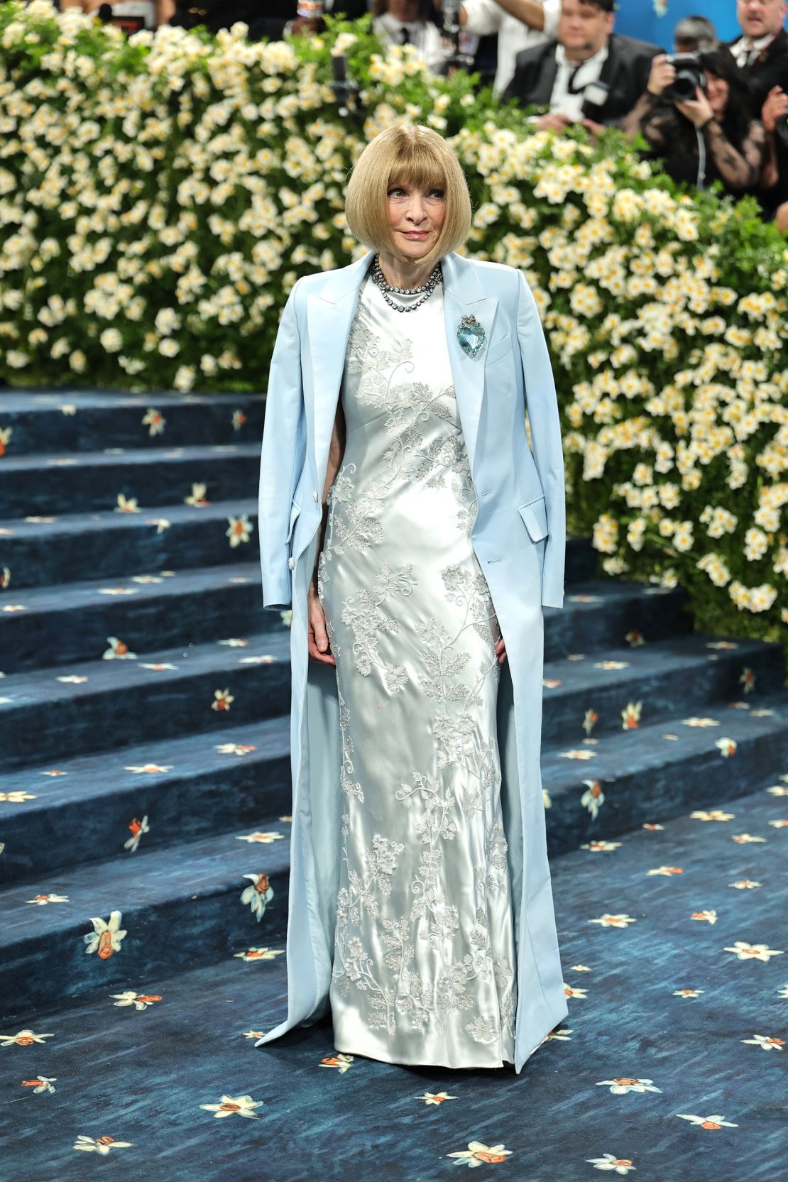 Anna Wintour, editor-in-chief of Vogue, wears a floor-length baby-blue coat designed by Pharrell Williams for Louis Vuitton.