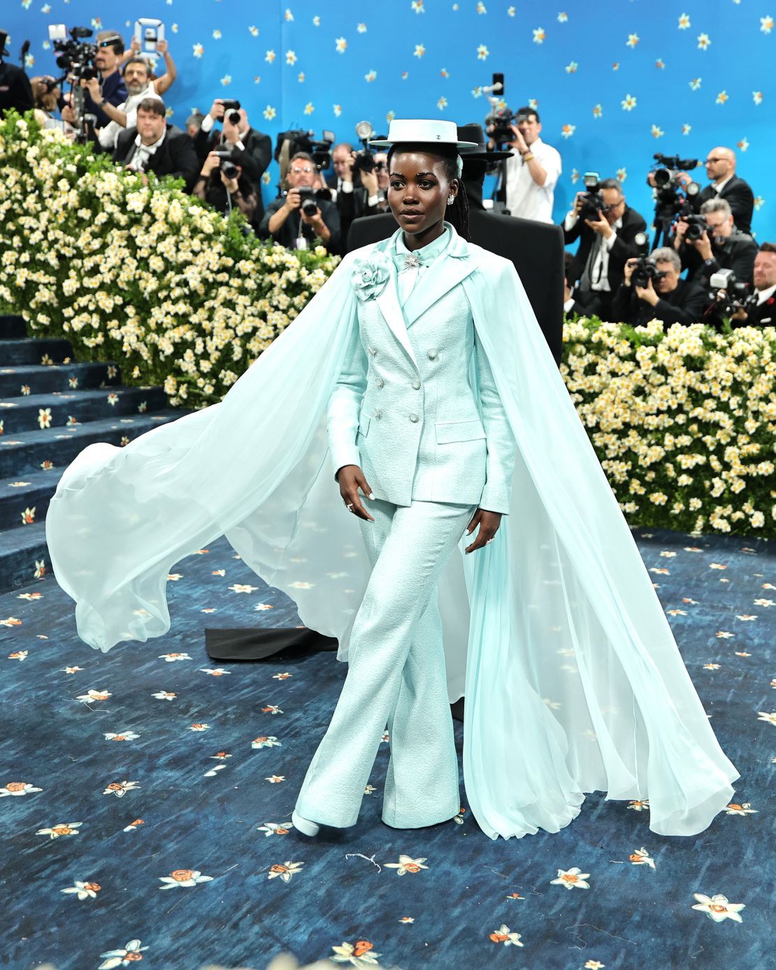Lupita Nyong’o, a Chanel brand ambassador, wore a custom aquamarine lurex wool jacket embellished with a satin collar. The Chanel ensemble references look No. 67 from the brand’s fall-winter 2015/16 haute couture collection.