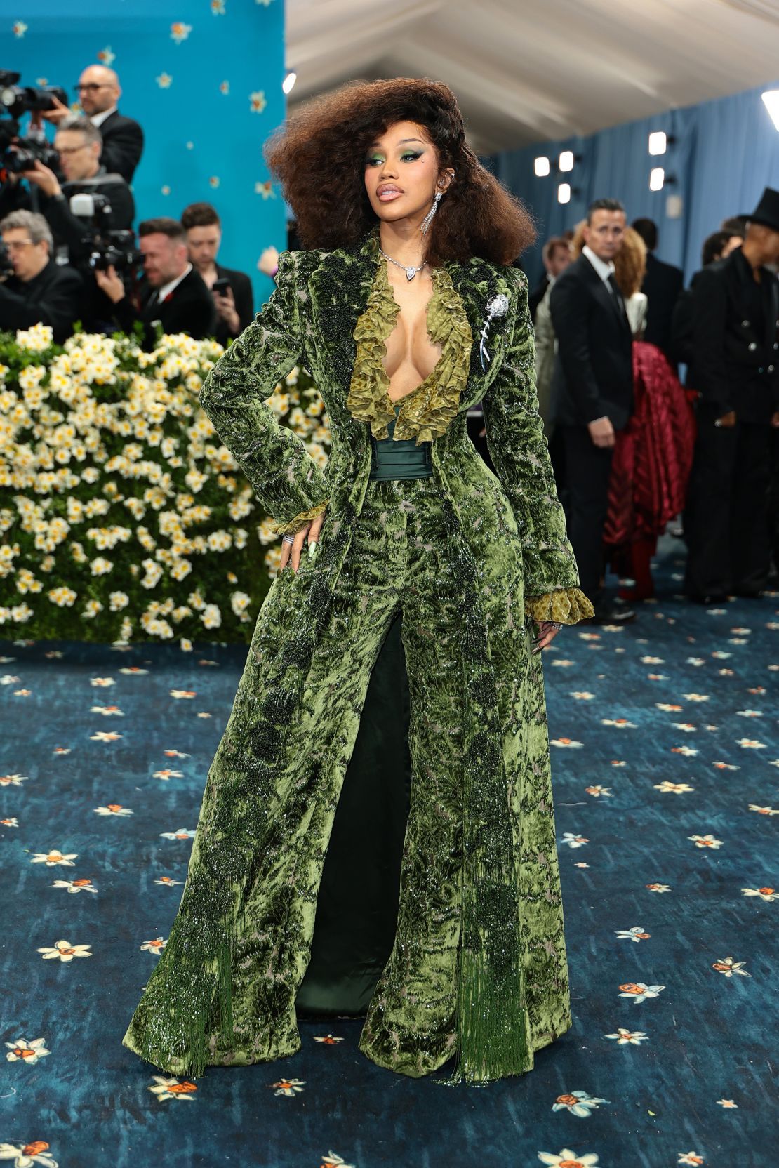 Cardi B in a lush green velvet Burberry suit with wide-legged pants.