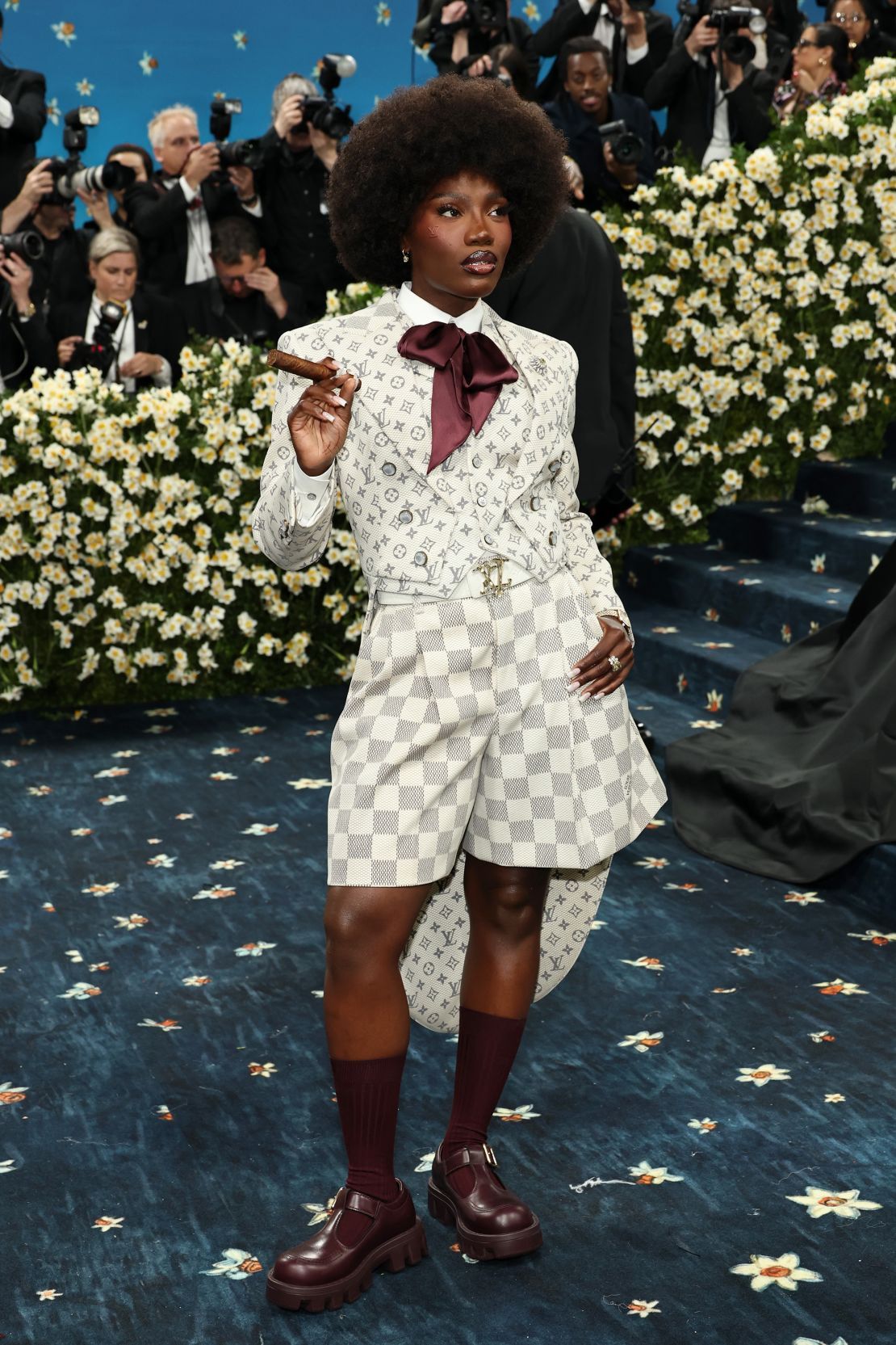 Doechii worked closely with Louis Vuitton creative director Pharrell Williams on her look, which was inspired by the book (“Slaves to Fashion: Black Dandyism and the Styling of Black Diasporic Identity”) that is the basis for the Costume Institute’s exhibition, the rapper told Vogue carpet co-hosts.