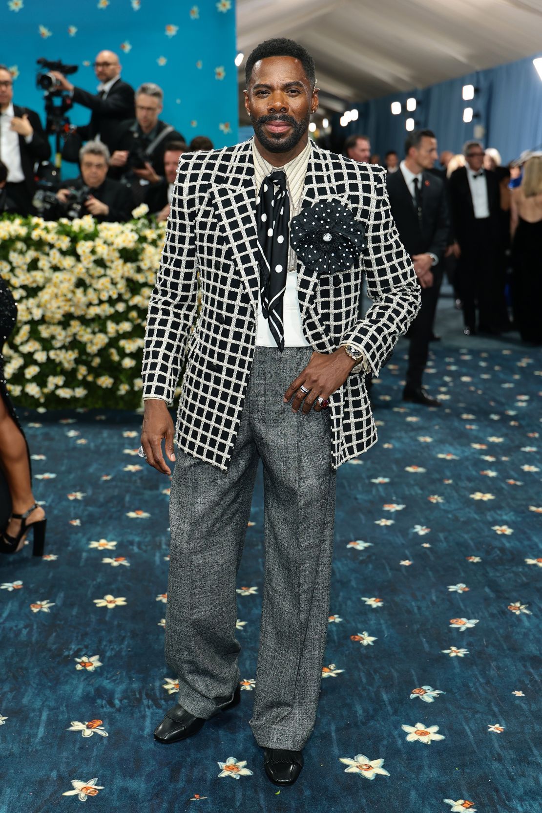Beneath the cape, Domingo wore a black and butter checkered wool Valentino jacket, embellished with pearl and crystal embroidery.