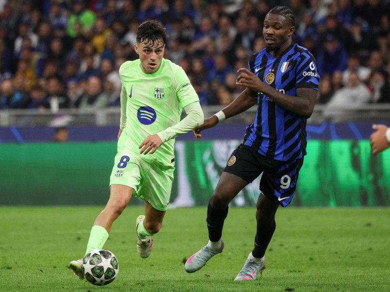 Pedri (left) of FC Barcelona in action against Marcus Thuram of the FC Inter during the second leg of the UEFA Champions League semifinals between Inter Milan and FC Barcelona, in Milan.