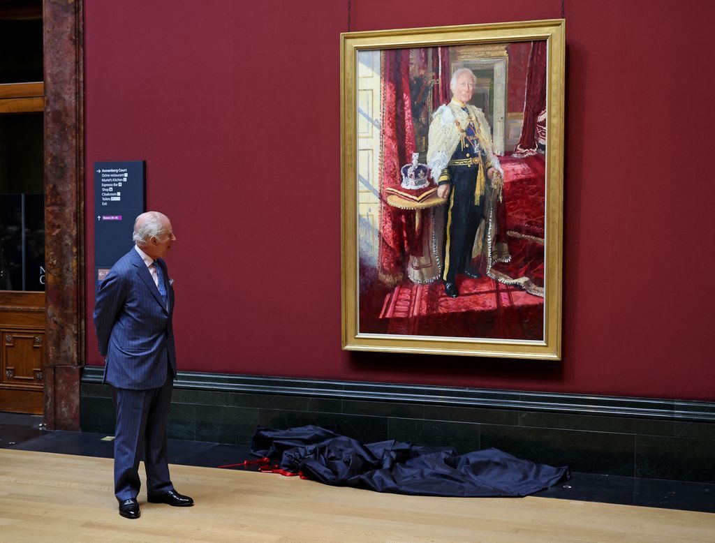 King Carlos III in front of his coronation picture
