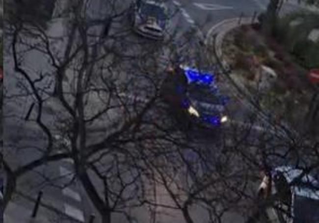 Police vehicles approach the boulevard area.