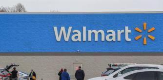 People are seen at the parking lot of a Walmart store