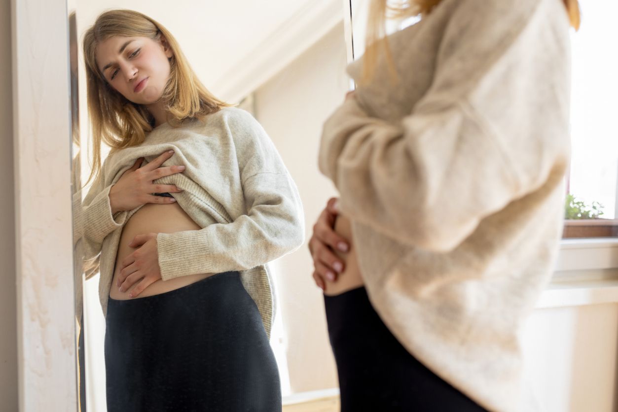 Woman with swollen belly.
