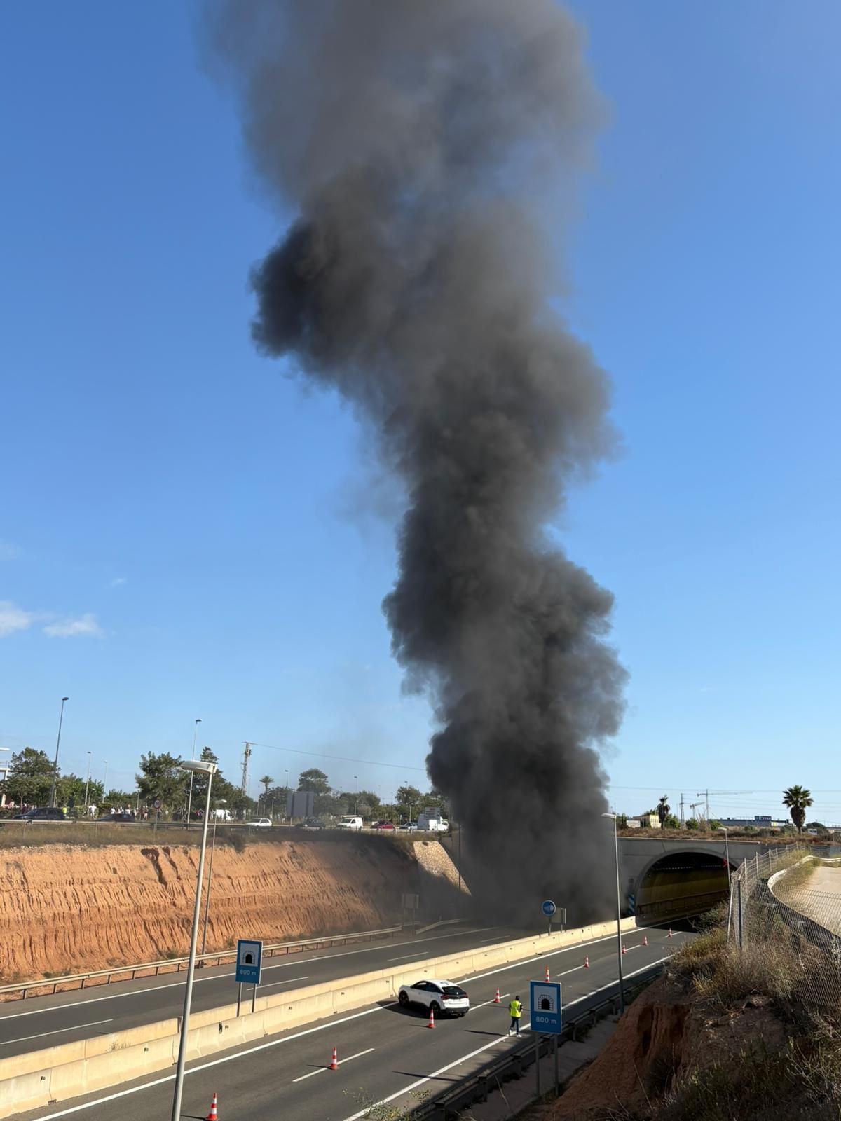 Smoke that emerges from the highway tunnel in Pilar de la Horadada
