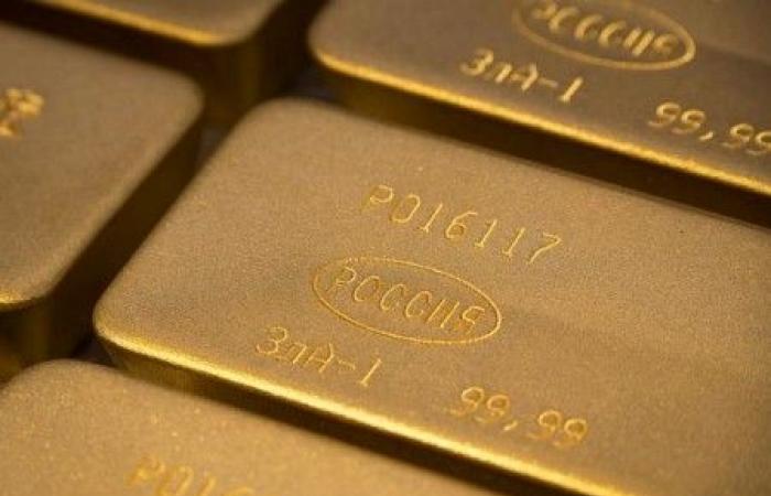 Gold falls to two-week low as higher dollar, yields dent appeal