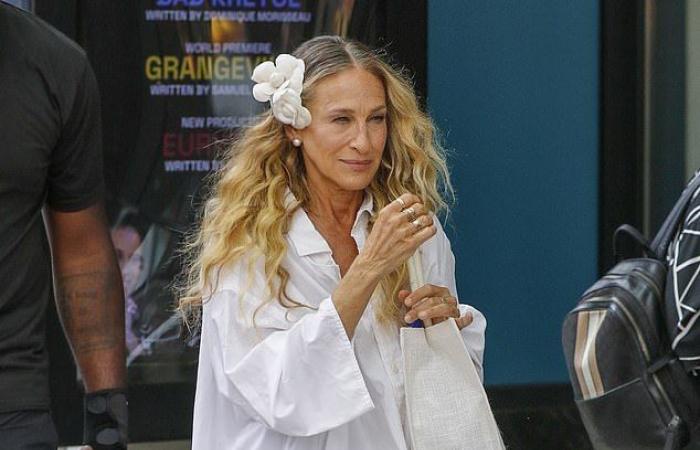 Sarah Jessica Parker sports a flower in her hair and an oversized white blouse after a day of filming the third season of And Simply Like That in New York.