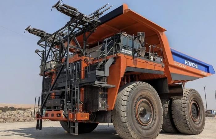 This giant mining dump truck charges its battery on the move