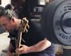 A man plays a Metallica bass solo while lifting more than a hundred kilos of weight