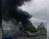 Inferno breaks out in car park with multiple vehicles ablaze as huge smoke plume fills the air