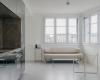 A small minimalist apartment grows thanks to its use of mirrors